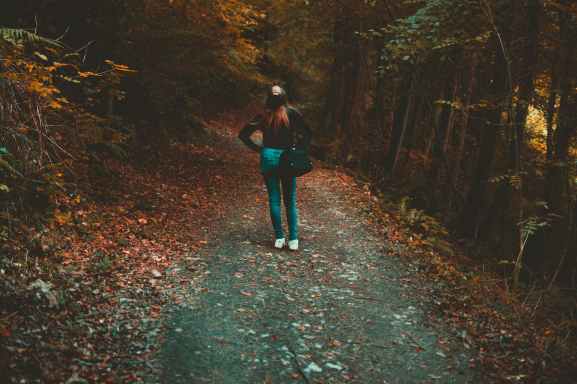 woman walking on forest trail