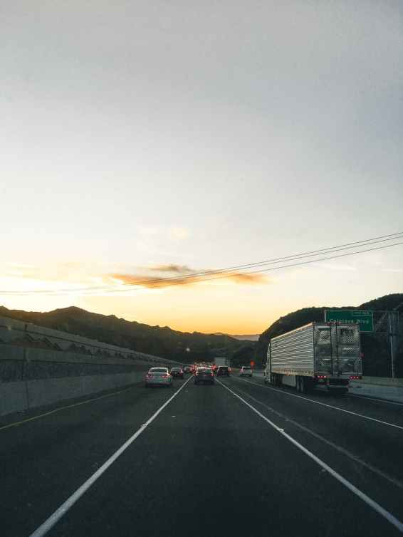 vehicles on road during golden hour
