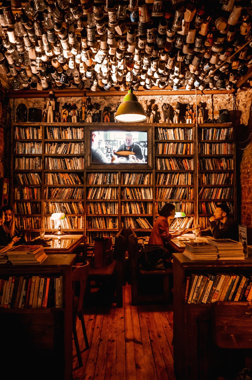 man and woman sitting on chair in library