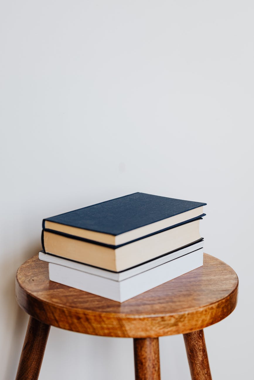 pile of books on wooden stool
