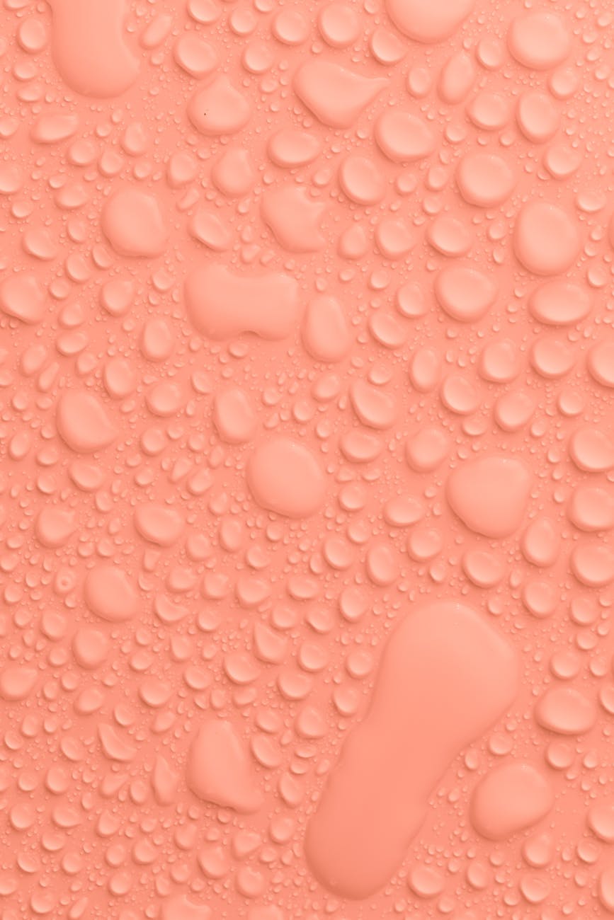 peach colored background with water drops