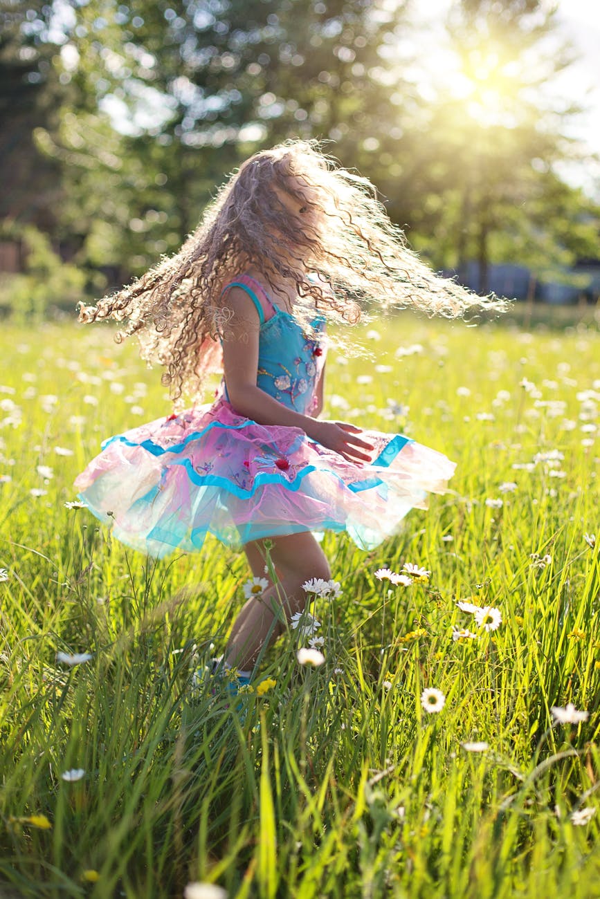 brown haired kid on grass field